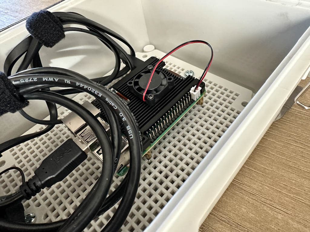 The inside of the BirdNet-Pi outdoor enclosure. You can see the black heat sink with the built-in fan. It was a pain to install on the Pi.