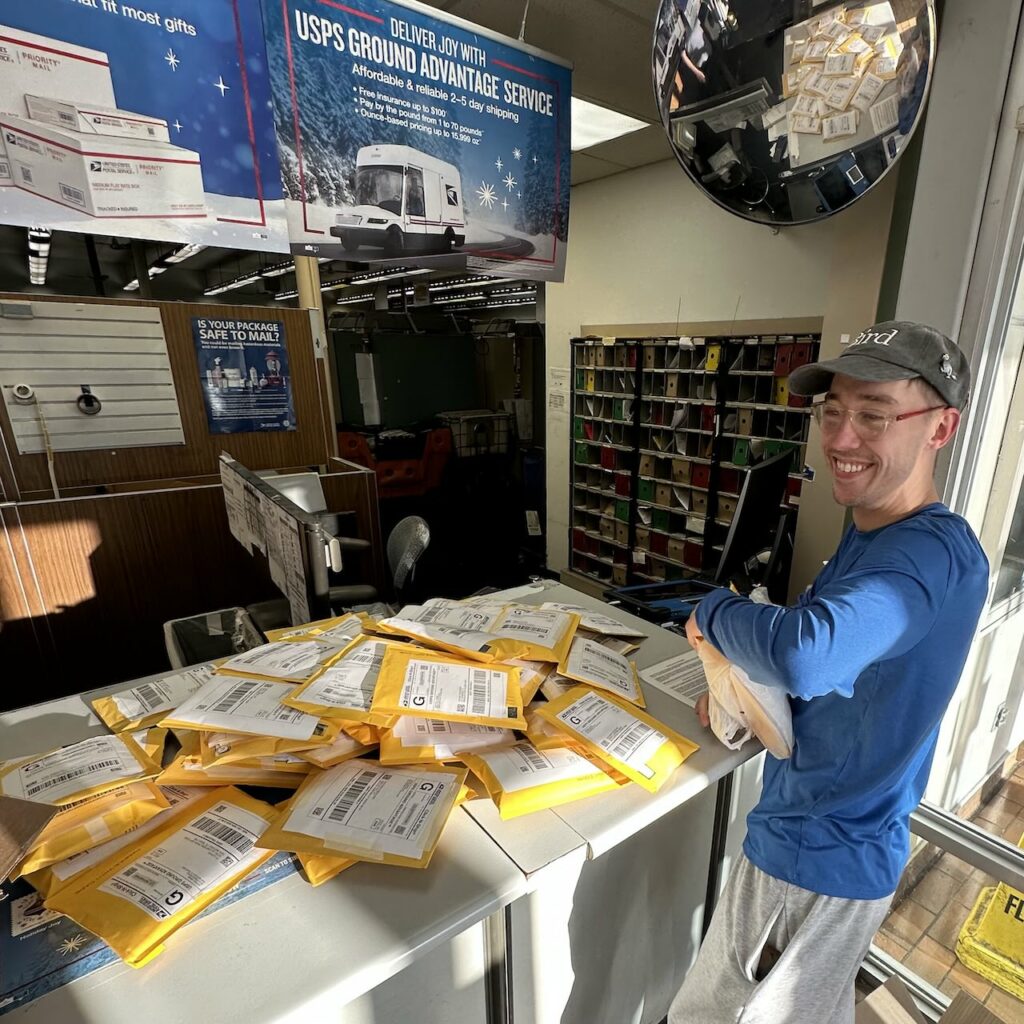 jeff with his pile of packages at the post office