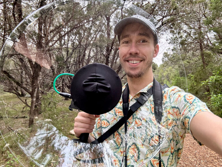 jeff with a wildtronics parabolic microphone in forest