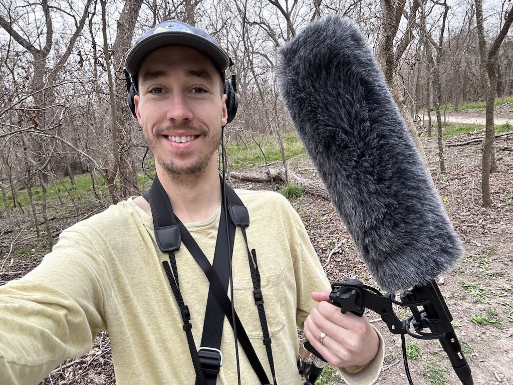 Jeff with a microphone outside to record birds