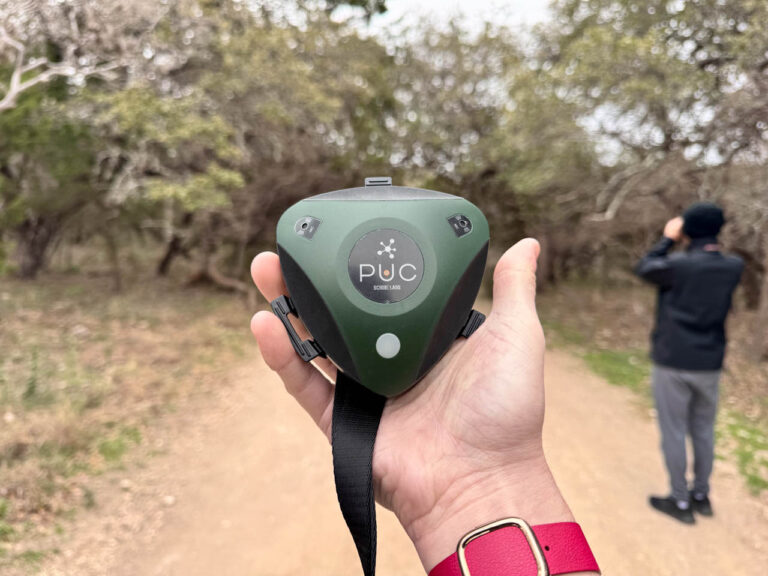 birdweather puc held in hand on hiking trail